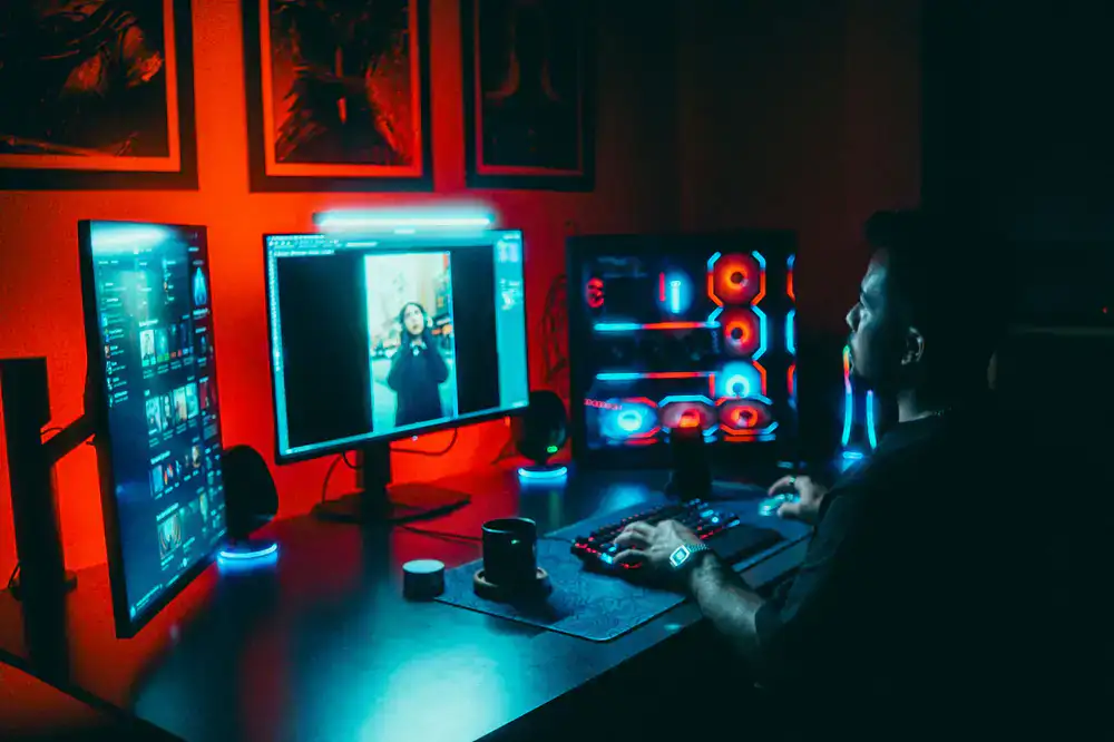 Game developers working at a colorful desk setup